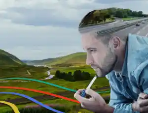 man looking at field for alternate paths for roads