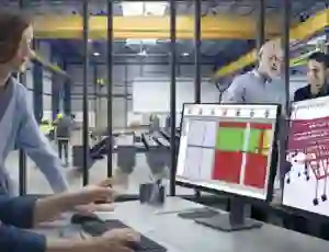 man and woman looking a computer with Tekla Powerfab open man and woman looking a computer with Tekla Powerfab open