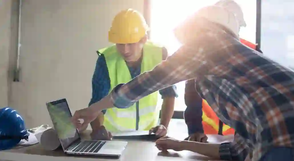 team crowded around computer