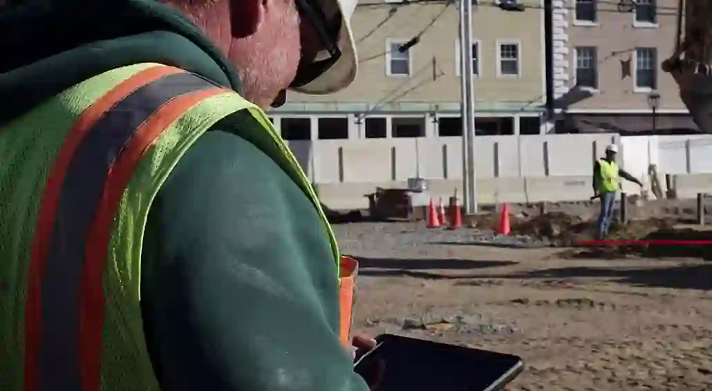man using tablet on worksite