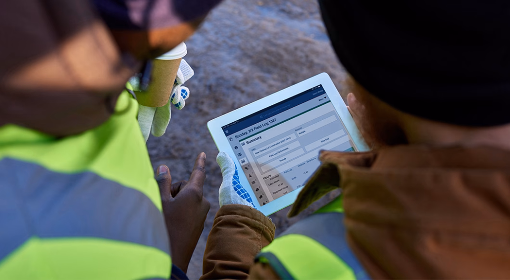 man using tablet on worksite